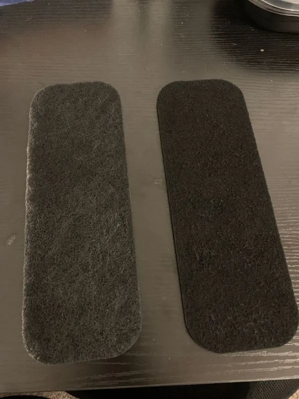 Two fresh carbon filter pads